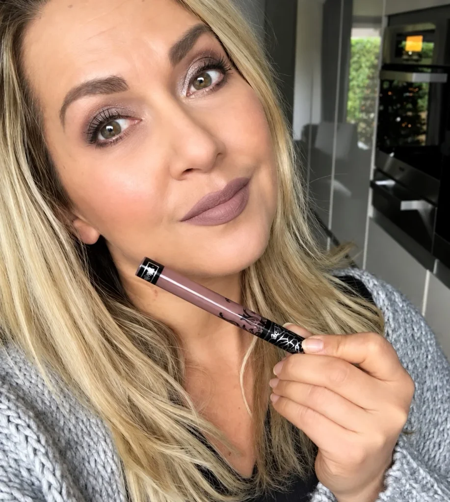Cool taupe lipstick in a muted gray-brown shade for understated, neutral lip makeup.