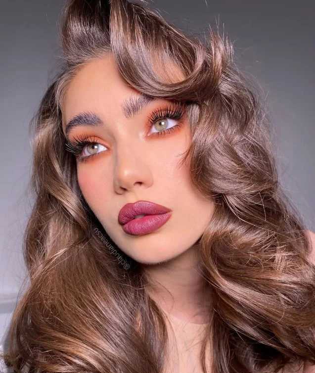 Cranberry lipstick in a deep berry-red shade with a cool-toned finish.