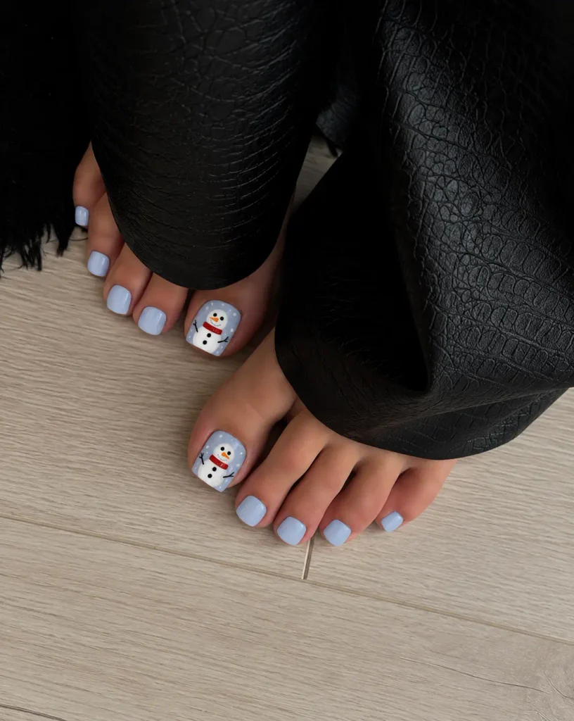 Christmas snowman toenail art with white snowmen, black eyes, orange noses, and scarves on the big toenails