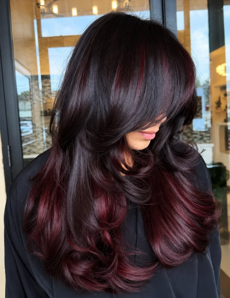Hidden cherry highlights beneath the top layer of dark brown hair