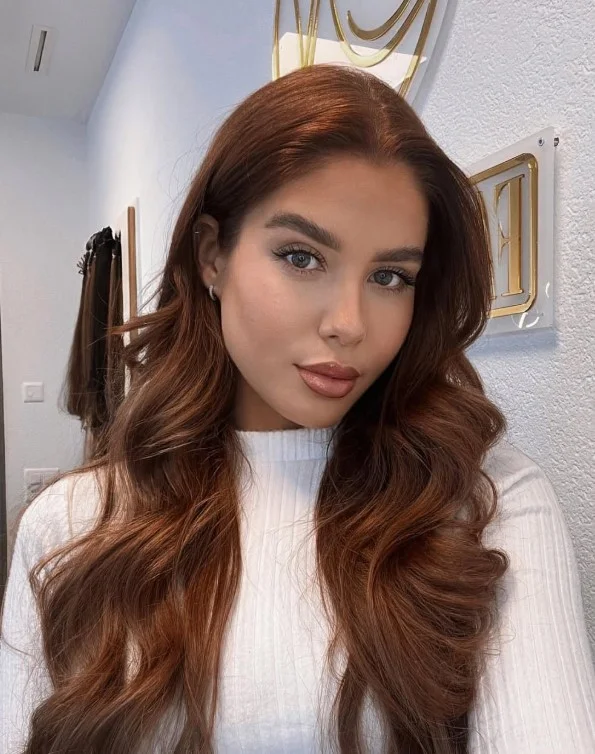 Woman with dark copper hair combining warm copper tones with deeper brown undertones