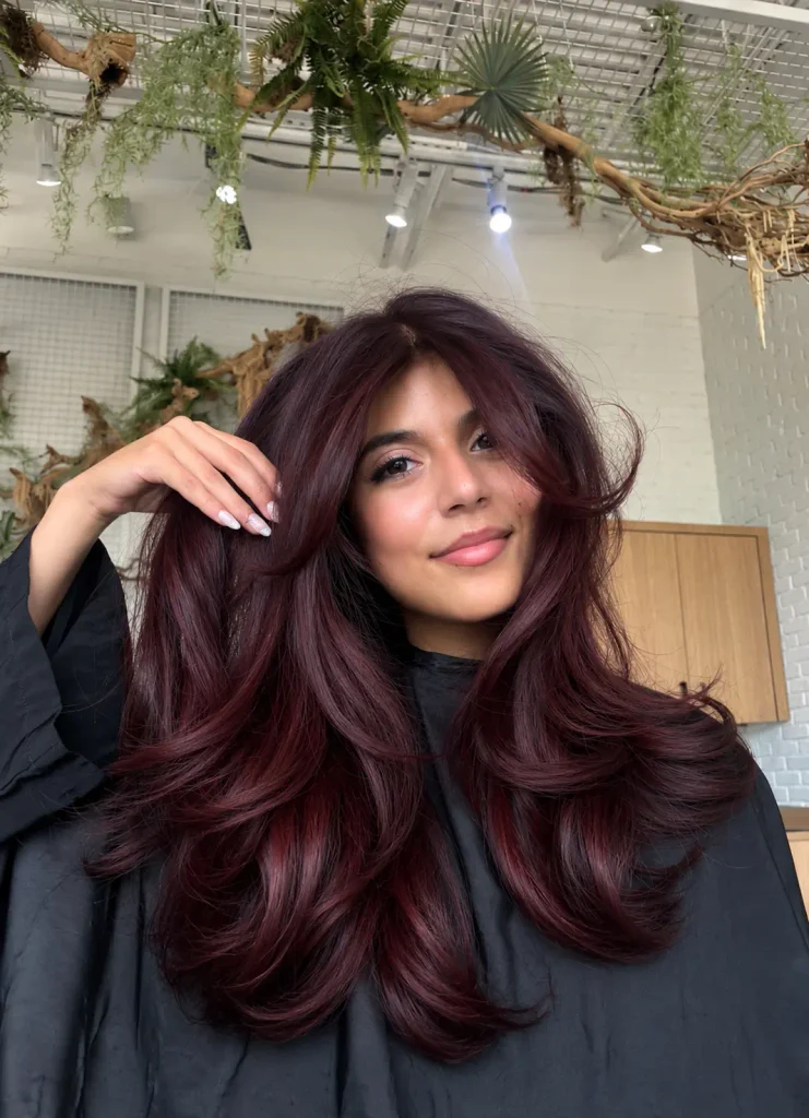 Deep cherry brown hair with darker burgundy lowlights for added depth