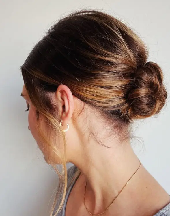 Elegant low chignon created with dark brown shoulder-length hair