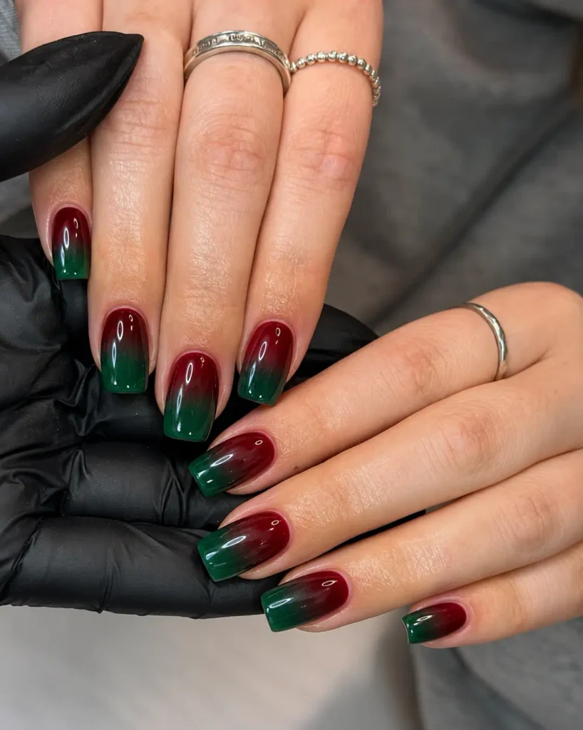 Emerald green and deep burgundy Christmas ombre nails with a gradual color blend and glossy finish