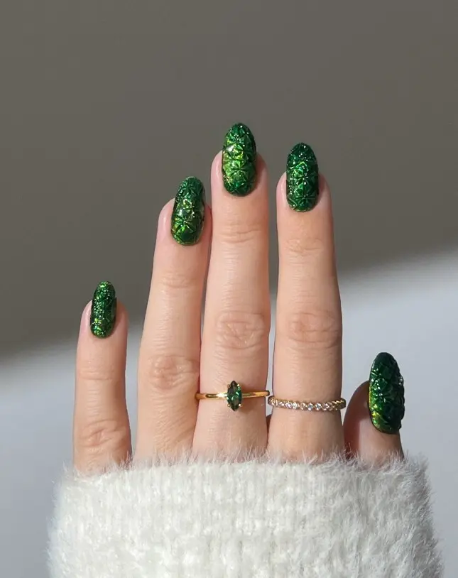 Emerald green Christmas nails embellished with small sparkling crystals or rhinestones near the cuticles