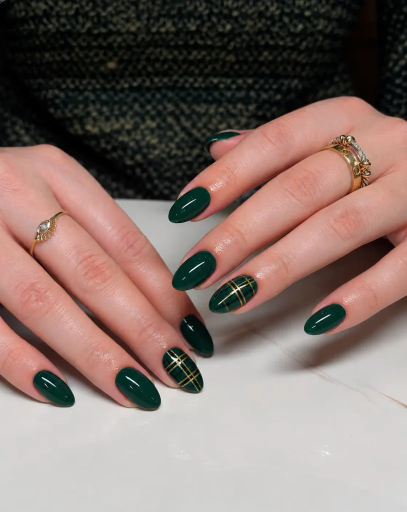 Emerald green Christmas plaid nails with thin intersecting gold lines creating a festive tartan pattern