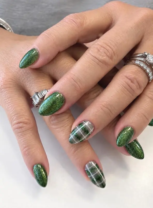 Emerald green glitter Christmas nails with gray and green plaid accent nails featuring fine white intersecting lines