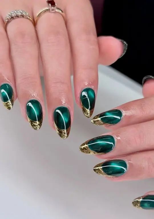 Emerald green Christmas nails with thin gold edging outlining the nails for an elegant green and gold manicure
