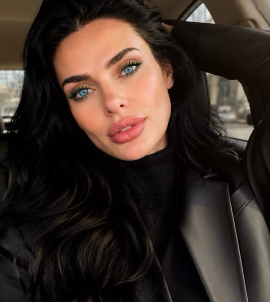 Woman with blue eyes wearing forest green mascara for a deep green colorful lash look
