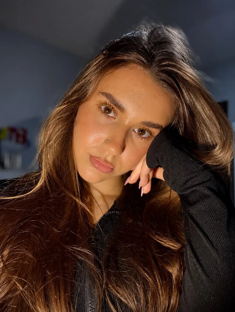 Woman with brown eyes wearing gold mascara for a luminous metallic lash look
