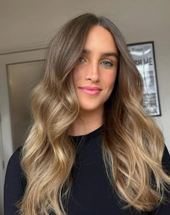 Golden bronde hair blending a brunette base with soft golden blonde highlights for a dimensional finish.