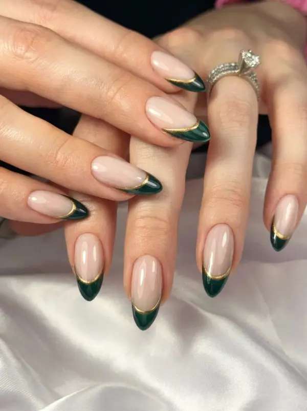 Green and gold double French tip nails with slim parallel colored lines over a sheer nude base