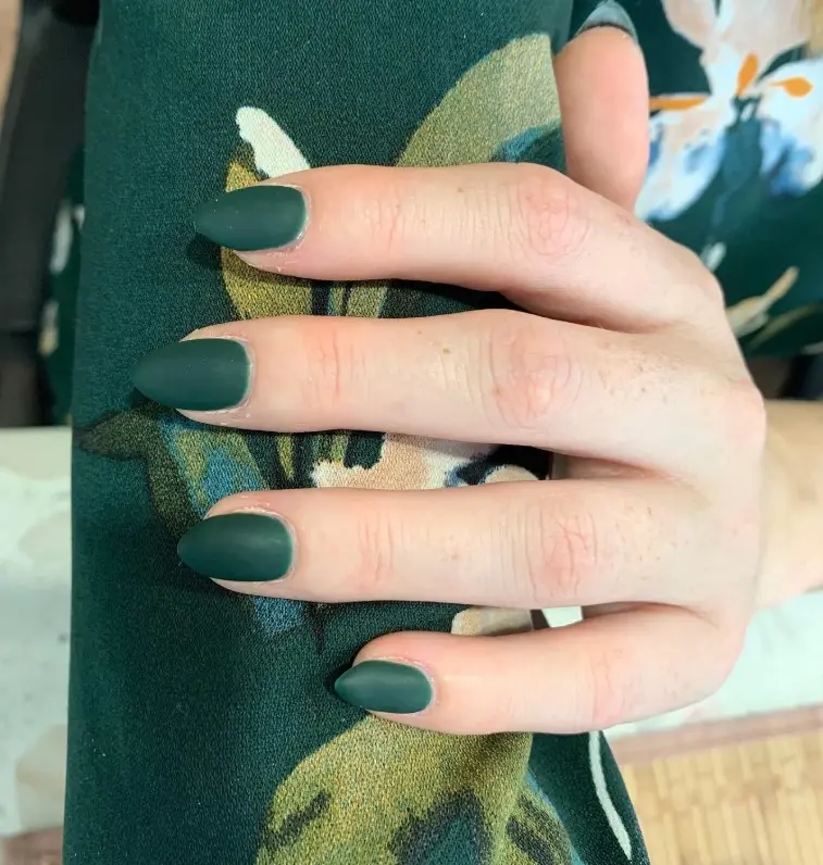 Matte emerald green Christmas nails with a smooth, velvety surface and understated minimalist styling