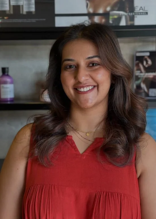 Woman with rich mocha brown hair featuring subtle tonal dimension and a glossy brunette finish