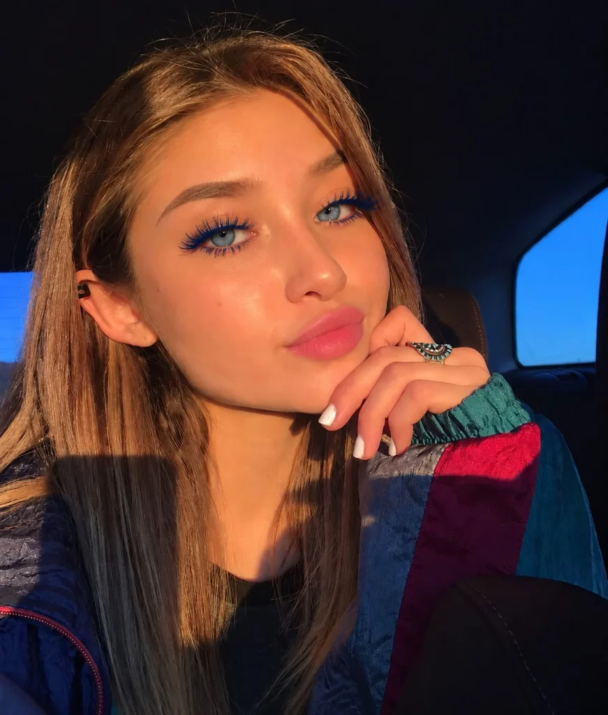 Woman with blue eyes wearing deep navy mascara with softly defined eye makeup