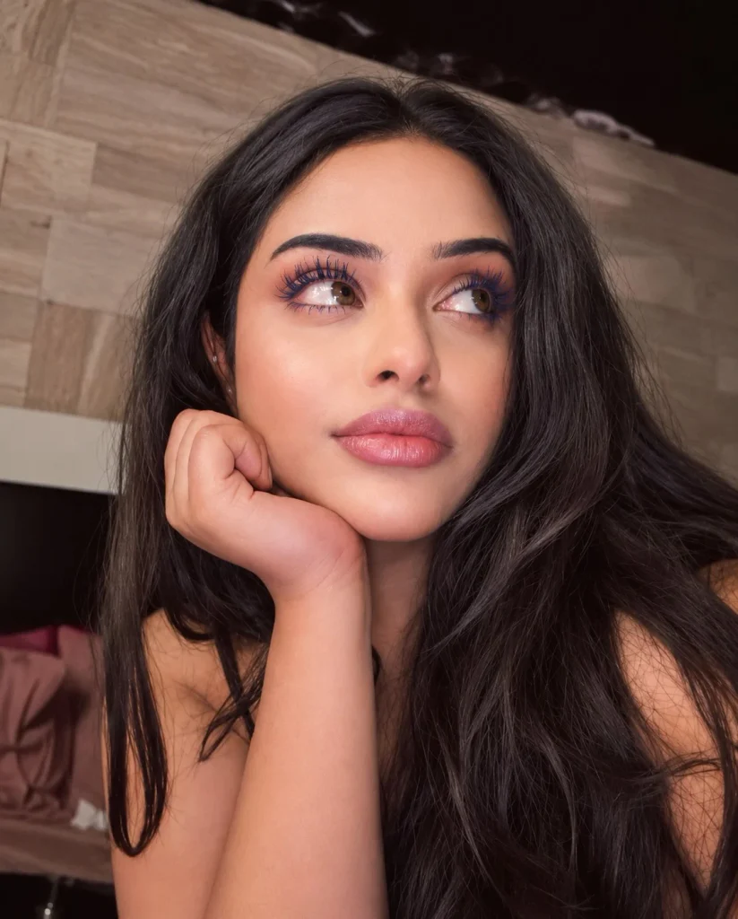 Woman with brown eyes wearing deep navy mascara with subtle eye makeup