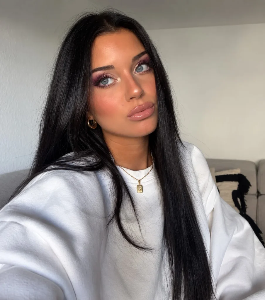 Blue eyes with deep plum eyeshadow blended into the outer corners and champagne shimmer highlighting the inner corners.