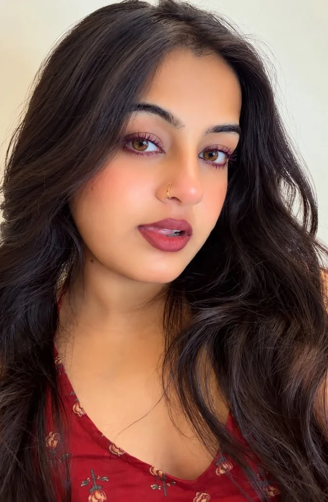 Woman with brown eyes wearing rich plum mascara for a soft colorful lash look