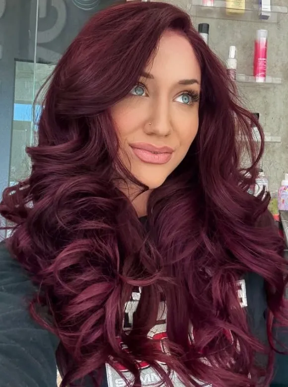 Dark plum red-brown hair with cool purple undertones.