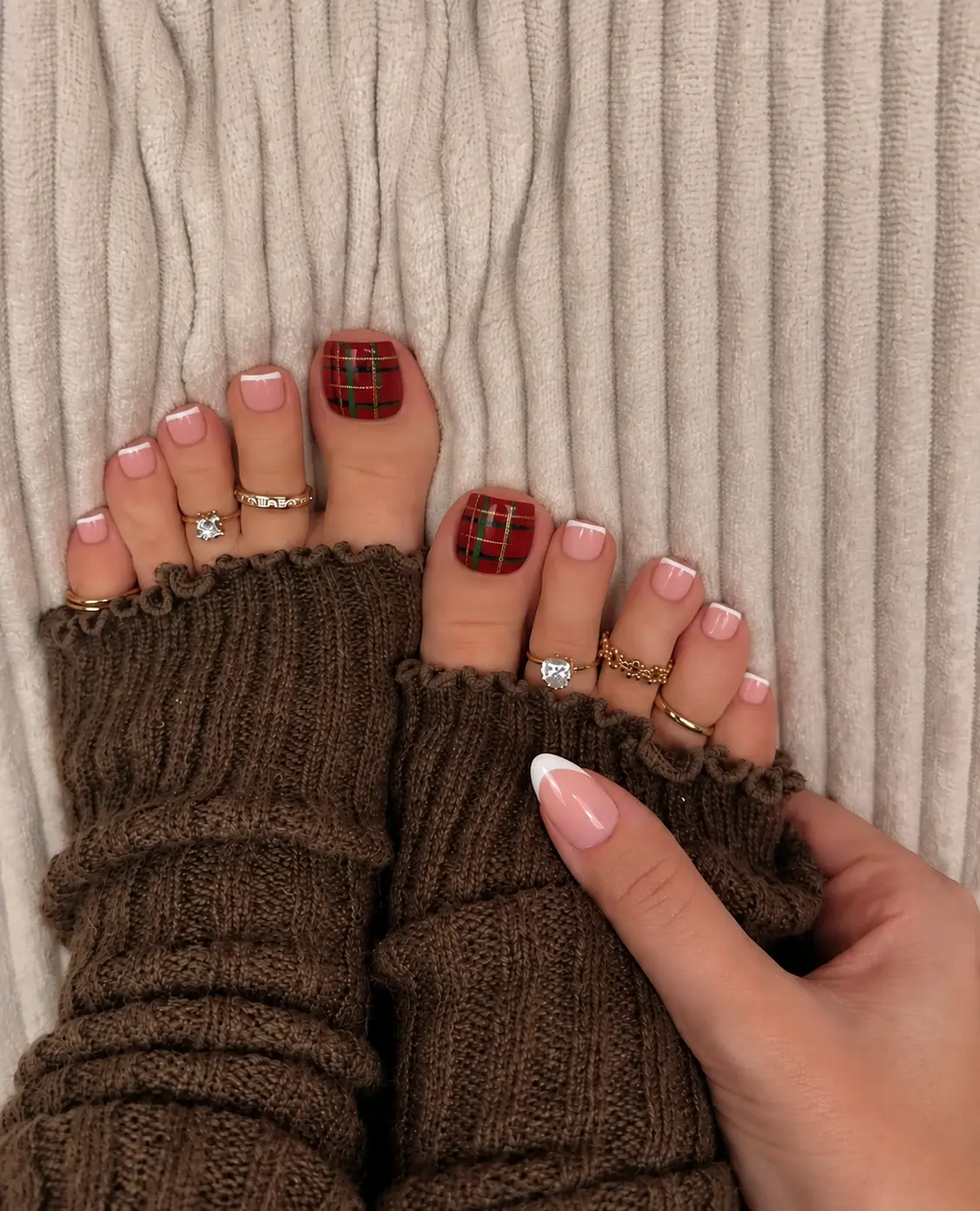 Red and green Christmas plaid toenail art with intersecting tartan lines on the big toenails