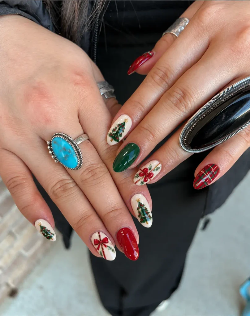 Green Christmas tree nail art with red ornaments and a gold star on a nude base