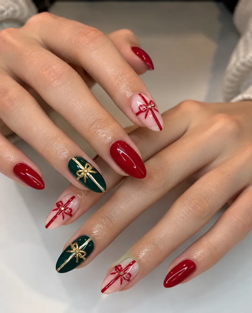Red and green Christmas gift-wrap nails with fine gold ribbon lines crossing the polish