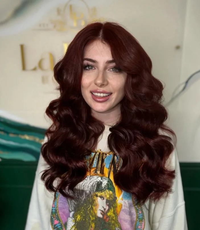 Rich auburn hair color for light olive skin with warm red and brown tones.