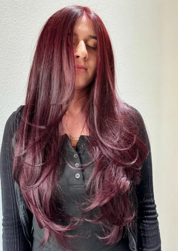 Rich ruby red-brown hair with a vivid red finish over a dark base.