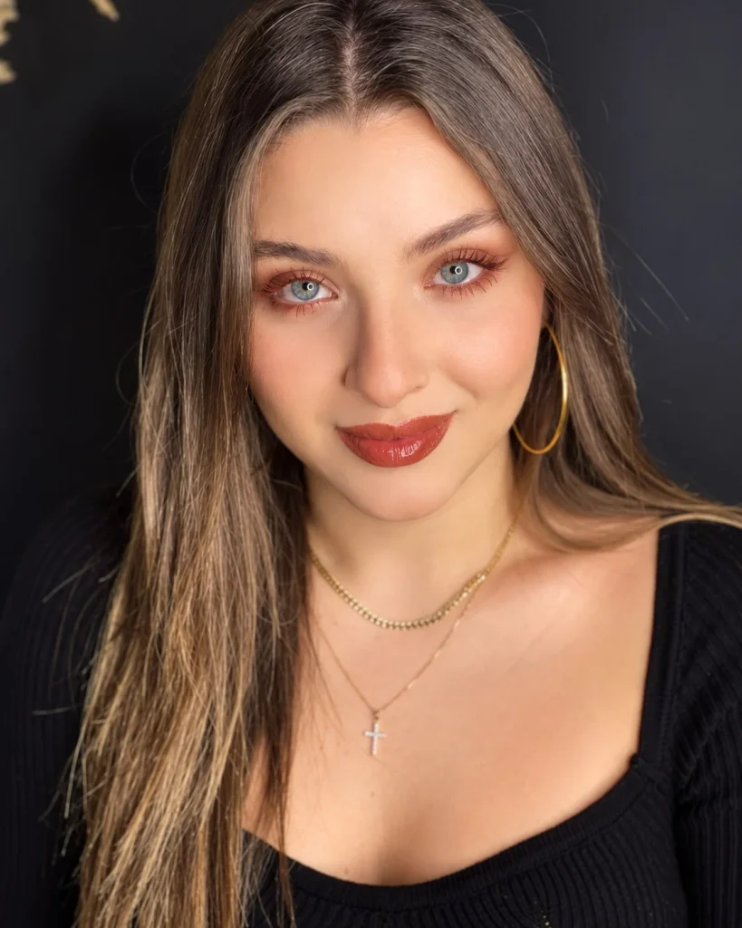 Woman with blue eyes wearing rust-colored mascara for a warm, distinctive lash look