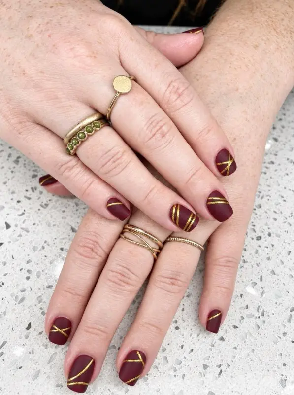 Short matte burgundy Christmas nails with a deep wine-red color and soft, velvety finish.
