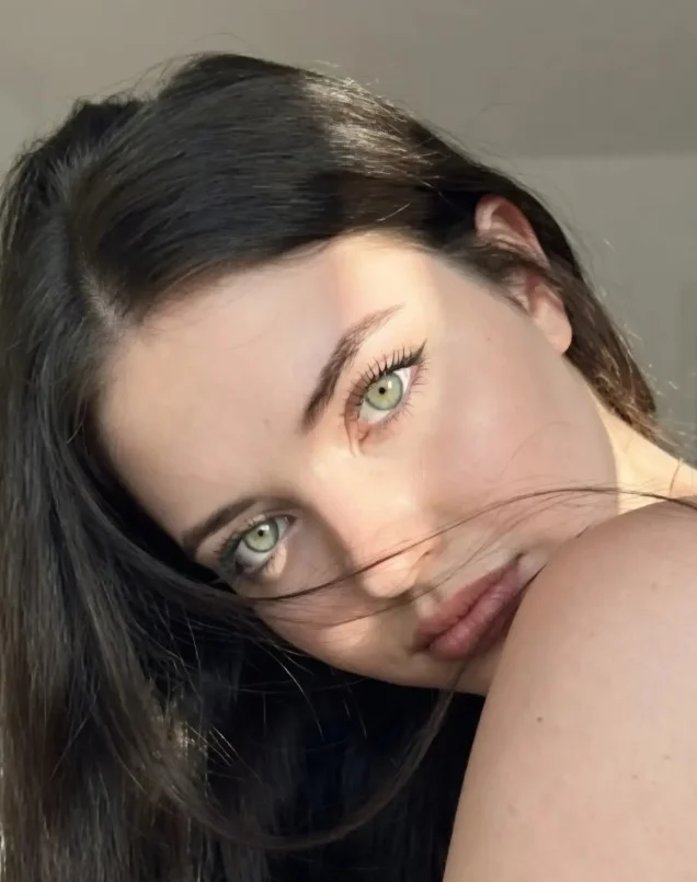 Woman with long, glossy soft black hair showcasing a deep, natural-looking color that creates contrast against fair skin.