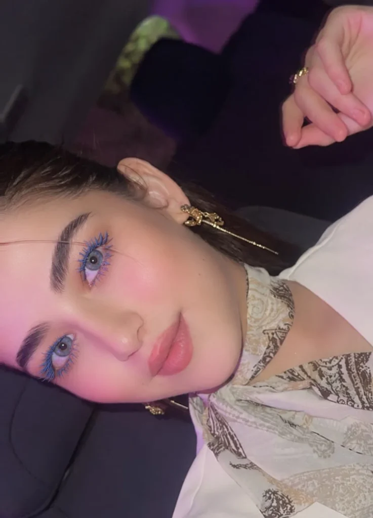 Woman with blue eyes wearing soft blue mascara for a light colorful makeup look