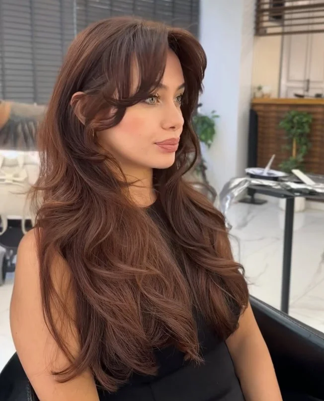 Soft chestnut brown hair color for light olive skin with subtle reddish-brown warmth and natural-looking dimension.