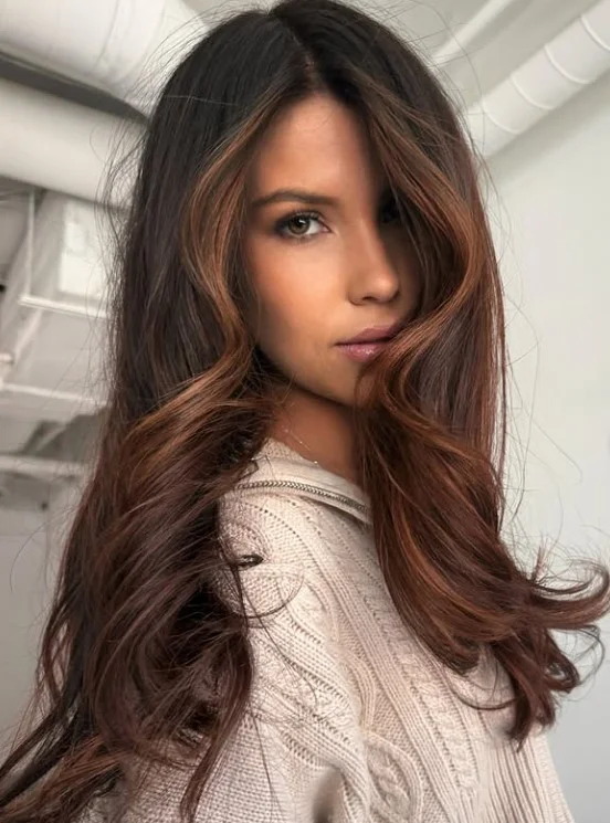 Woman with soft cinnamon brown hair featuring warm brown and subtle copper tones