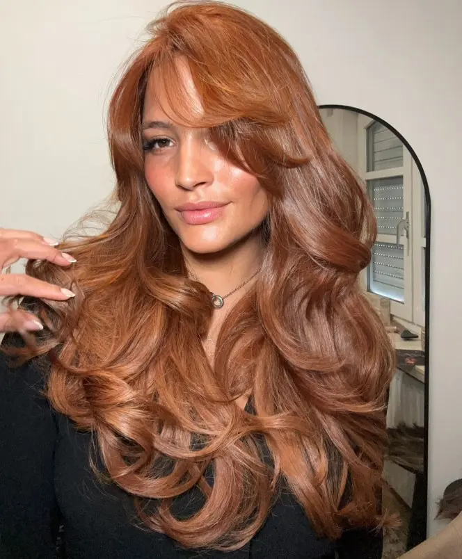 Soft copper blonde hair with warm golden-red tones.
