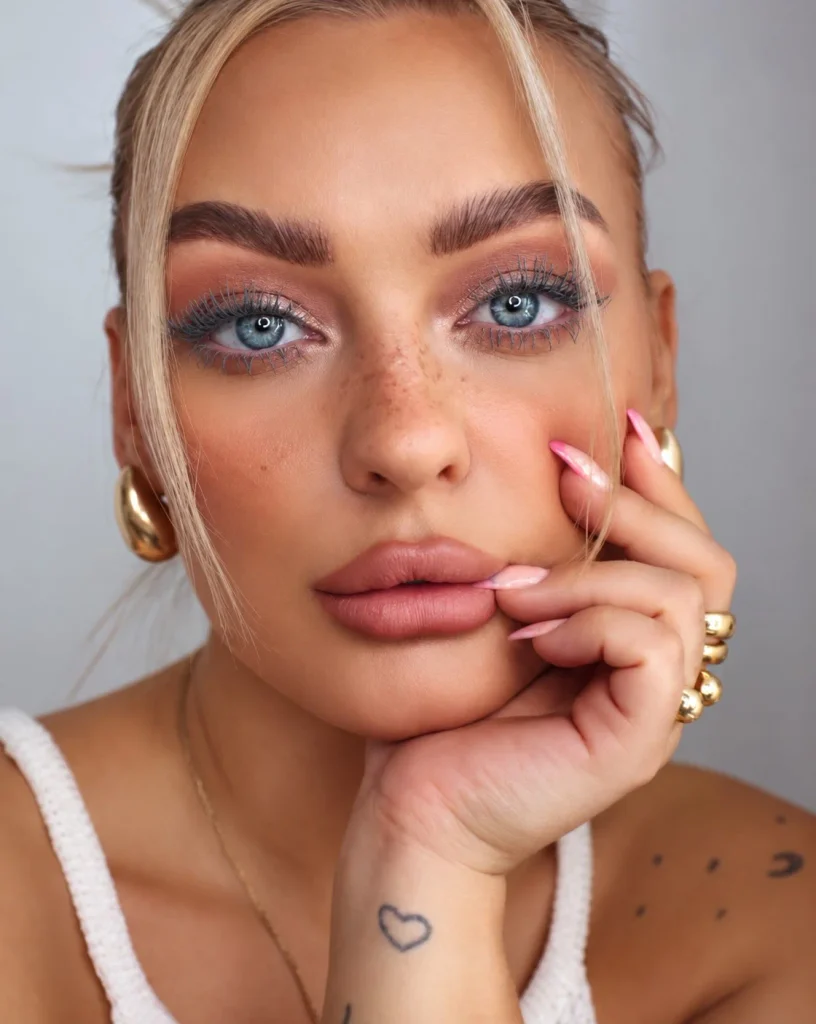 Woman with blue eyes wearing soft gray mascara for a subtle, understated lash look